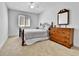 Bedroom with a cozy bed, ceiling fan, a window, and classic wooden dresser at 11788 E Atlantic Pl, Aurora, CO 80014