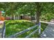 View of a home featuring mature trees, a well-maintained lawn, and a cozy, inviting entrance at 11788 E Atlantic Pl, Aurora, CO 80014