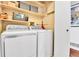 Laundry room featuring a modern washer and dryer, with overhead shelving at 11788 E Atlantic Pl, Aurora, CO 80014