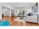 Bright living room with hardwood floors, large window, and comfortable seating area at 11788 E Atlantic Pl, Aurora, CO 80014