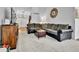 Open-concept living room featuring a large sectional sofa and stylish furnishings at 11788 E Atlantic Pl, Aurora, CO 80014