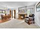 Inviting living room with a fireplace, built-in shelving, and an open dining area at 11788 E Atlantic Pl, Aurora, CO 80014
