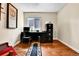 Functional office with wooden floors, desk, and filing cabinet at 11788 E Atlantic Pl, Aurora, CO 80014
