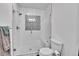 Glass enclosed shower with white tile and patterned accent tile at 11788 E Atlantic Pl, Aurora, CO 80014