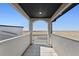 Balcony featuring arched entrance and open views of the surrounding landscape at 12450 Watkins Rd, Hudson, CO 80642