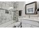 Modern bathroom features a marble-tiled shower, sleek vanity, and contemporary fixtures at 12450 Watkins Rd, Hudson, CO 80642