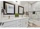 Bright bathroom featuring double sinks, modern vanity, and tiled shower-tub combination at 12450 Watkins Rd, Hudson, CO 80642