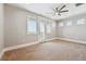 Bedroom with plush carpet, ceiling fan, and access to outdoor balcony at 12450 Watkins Rd, Hudson, CO 80642