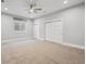 Bright and airy bedroom features large windows, a ceiling fan, and a spacious closet at 12450 Watkins Rd, Hudson, CO 80642