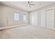 Bright bedroom with neutral colors, large windows offering scenic views, and ample closet space at 12450 Watkins Rd, Hudson, CO 80642