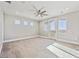 Sunny bedroom with plush carpet, ceiling fan, and access to outdoor balcony at 12450 Watkins Rd, Hudson, CO 80642