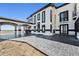 Stately home featuring white stucco and black trim with an elegant covered patio at 12450 Watkins Rd, Hudson, CO 80642