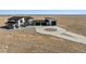 Aerial view of modern home with large driveway and a three-car garage at 12450 Watkins Rd, Hudson, CO 80642