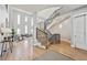 Bright and airy foyer with high ceilings and a modern curved staircase at 12450 Watkins Rd, Hudson, CO 80642