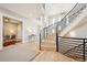 Beautiful foyer featuring a contemporary curved staircase and stylish decor at 12450 Watkins Rd, Hudson, CO 80642