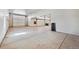 Spacious garage with multiple overhead doors and concrete flooring at 12450 Watkins Rd, Hudson, CO 80642