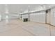 Spacious garage with multiple doors, ample lighting, and a clean, modern design at 12450 Watkins Rd, Hudson, CO 80642