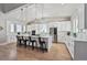 Spacious kitchen with a large central island, stainless steel appliances, and sleek white cabinetry at 12450 Watkins Rd, Hudson, CO 80642