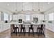 Bright kitchen features a large island with seating, stainless appliances, and white cabinets at 12450 Watkins Rd, Hudson, CO 80642