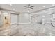 Open living area with tile flooring, access to wet bar, and recessed lighting at 12450 Watkins Rd, Hudson, CO 80642