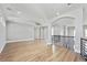 Spacious living room with hardwood floors, archways, and views of staircase at 12450 Watkins Rd, Hudson, CO 80642