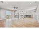 Bright living room with hardwood floors, large sliding glass doors, and modern fixtures at 12450 Watkins Rd, Hudson, CO 80642