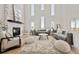Spacious living room with high ceilings, large windows, and stylish furniture at 12450 Watkins Rd, Hudson, CO 80642