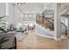 Open-concept living room with modern staircase and abundant natural light at 12450 Watkins Rd, Hudson, CO 80642