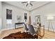 Cozy home office featuring a glass desk, plush rug, and ample natural light from windows at 12450 Watkins Rd, Hudson, CO 80642
