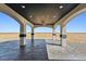 Covered patio with stone pavers and arched support beams showcasing outdoor space at 12450 Watkins Rd, Hudson, CO 80642