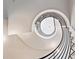Unique view of winding staircase with overhead light fixture at 12450 Watkins Rd, Hudson, CO 80642