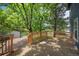 The back deck is spacious and surrounded by mature trees offering shade at 9569 Elk Mountain Cir, Littleton, CO 80125