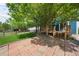 The backyard features a brick patio, deck and mature landscaping at 9569 Elk Mountain Cir, Littleton, CO 80125