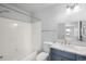 Bright bathroom featuring a shower-tub combo, modern fixtures, and a sleek vanity at 9569 Elk Mountain Cir, Littleton, CO 80125
