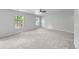 Spacious bedroom with carpet, ceiling fan and two large windows at 9569 Elk Mountain Cir, Littleton, CO 80125