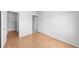 Bright bedroom featuring wood-look floors, a closet, and an ensuite bathroom at 9569 Elk Mountain Cir, Littleton, CO 80125