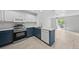 Modern kitchen featuring stainless steel appliances, gray countertops, and white cabinets at 9569 Elk Mountain Cir, Littleton, CO 80125