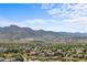 Beautiful neighborhood view with a lake and scenic mountain backdrop at 9569 Elk Mountain Cir, Littleton, CO 80125
