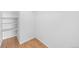 Bright walk-in closet featuring built-in shelving with wood-look floors at 9569 Elk Mountain Cir, Littleton, CO 80125