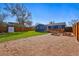 Spacious backyard featuring a gravel area, a wooden deck, and garden boxes at 1390 S Glencoe St, Denver, CO 80222