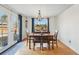 Bright dining room featuring a modern chandelier, and glass doors leading to the backyard at 1390 S Glencoe St, Denver, CO 80222