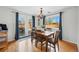Bright dining room with a stylish chandelier and access to an outdoor deck at 1390 S Glencoe St, Denver, CO 80222