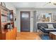 Inviting entryway boasts hardwood floors, stylish door, and ample natural light, complemented by a chic cabinet at 1390 S Glencoe St, Denver, CO 80222