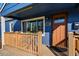 Charming blue home featuring a covered front porch, a welcoming front door, and a well-manicured entrance at 1390 S Glencoe St, Denver, CO 80222