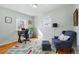 Bright home office featuring hardwood floors, natural light, and comfortable seating at 1390 S Glencoe St, Denver, CO 80222