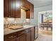 Charming kitchen with custom cabinetry and a dining area visible in the background at 1390 S Glencoe St, Denver, CO 80222