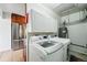 Functional laundry room with modern appliances and ample storage space near the kitchen at 1390 S Glencoe St, Denver, CO 80222