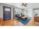 Cozy living room with hardwood floors, a gray-painted walls and a stylish front door at 1390 S Glencoe St, Denver, CO 80222
