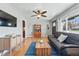 Spacious living room featuring hardwood floors, a ceiling fan, and a comfortable sofa, creating a welcoming space at 1390 S Glencoe St, Denver, CO 80222