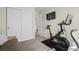 This carpeted room features a closet, an exercise bike, and access to a small desk area at 17808 E 104Th Pl # C, Commerce City, CO 80022